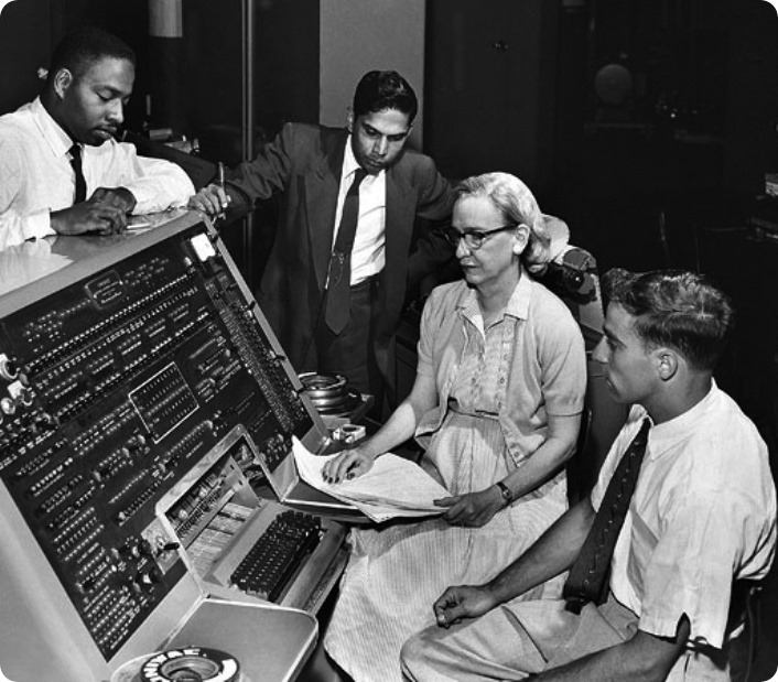 <i>SI Neg. 83-14878. Date: na.</i> Grace Murray Hopper at the UNIVAC keyboard, c. 1960. Grace Brewster Murray: American mathematician and rear admiral in the U.S. Navy who was a pioneer in developing computer technology, helping to devise UNIVAC I. the first commercial electronic computer, and naval applications for COBOL (common-business-oriented language). Credit: Unknown (Smithsonian Institution)